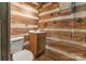 Bathroom featuring log walls, a wooden vanity, and a toilet at 1513 Shelby Hwy, Cherryville, NC 28021