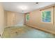 Cozy carpeted bedroom with patterned wallpaper, two windows, and a closet door at 1513 Shelby Hwy, Cherryville, NC 28021