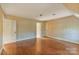 Large bedroom featuring hardwood floors, patterned wallpaper, and a neutral trim at 1513 Shelby Hwy, Cherryville, NC 28021