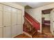 Inviting entryway featuring hardwood floors, coat closet, and stairs leading to the upper level of the home at 1513 Shelby Hwy, Cherryville, NC 28021