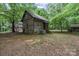 Exterior view of a rustic cabin with mature trees at 1513 Shelby Hwy, Cherryville, NC 28021