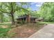 Picturesque home with a charming porch, surrounded by mature trees and lush landscaping at 1513 Shelby Hwy, Cherryville, NC 28021
