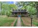 Charming two-story home with a cozy front porch, dormer windows, and a lush green lawn at 1513 Shelby Hwy, Cherryville, NC 28021