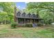 Charming home featuring a cozy porch, dormer windows, brick chimney, and landscaped front yard at 1513 Shelby Hwy, Cherryville, NC 28021