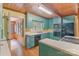 Charming kitchen features wood ceilings, blue cabinets, and modern appliances, offering a warm, inviting space at 1513 Shelby Hwy, Cherryville, NC 28021