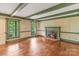 Spacious living room featuring hardwood floors, a fireplace, and large windows with a backyard view at 1513 Shelby Hwy, Cherryville, NC 28021