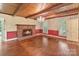 Cozy living room with hardwood floors, brick fireplace, chandelier, and natural light from large windows at 1513 Shelby Hwy, Cherryville, NC 28021