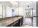 Bathroom vanity with granite countertop, dark wood cabinets, and a large mirror at 15637 Guthrie Dr, Huntersville, NC 28078