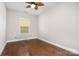A bedroom showcasing natural light from the window and hardwood flooring at 15637 Guthrie Dr, Huntersville, NC 28078