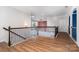 Second floor common area showcasing hardwood floors and decorative railings at 15637 Guthrie Dr, Huntersville, NC 28078