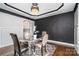 Stylish dining room with decorative wall paneling and modern chandelier at 15637 Guthrie Dr, Huntersville, NC 28078