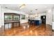 Open-concept kitchen with an island, hardwood floors, and views into the living area at 15637 Guthrie Dr, Huntersville, NC 28078