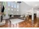 Spacious living room with stone fireplace, hardwood floors, and ample natural light at 15637 Guthrie Dr, Huntersville, NC 28078