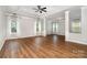 Spacious living room featuring lots of natural light, hardwood floors, and white support columns at 15637 Guthrie Dr, Huntersville, NC 28078