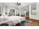 Spacious main bedroom with wood floors, sitting area, natural light, and ceiling fan at 15637 Guthrie Dr, Huntersville, NC 28078