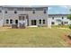 Townhouse backyard with patio, lawn, and exterior AC units at 1712 Braemar Village Dr, Monroe, NC 28110