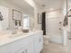 Bright bathroom with a double vanity, white cabinets, and a shower-tub combination at 1712 Braemar Village Dr, Monroe, NC 28110
