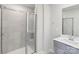 Bathroom featuring a shower with a glass door and a single vanity sink with gray cabinets at 1712 Braemar Village Dr, Monroe, NC 28110