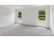 Bedroom with plush carpet, two windows that provide natural light, and neutral walls at 1712 Braemar Village Dr, Monroe, NC 28110