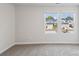 Bright bedroom with plush carpet, neutral walls, and two windows offering neighborhood views at 1712 Braemar Village Dr, Monroe, NC 28110