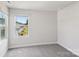 Bright bedroom with neutral walls and carpet, showcasing a window view at 1712 Braemar Village Dr, Monroe, NC 28110