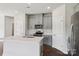 Modern kitchen with gray cabinets, stainless steel appliances, subway tile backsplash, and a white island at 1712 Braemar Village Dr, Monroe, NC 28110