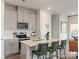 Modern kitchen featuring stainless steel appliances, a breakfast bar, and sleek gray cabinets at 1712 Braemar Village Dr, Monroe, NC 28110