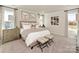 Spacious main bedroom with large windows, neutral tones, and stylish furnishings at 1712 Braemar Village Dr, Monroe, NC 28110