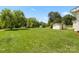 Expansive backyard featuring lush green grass, mature trees, and a storage shed at 1725 Fallston Rd, Shelby, NC 28150
