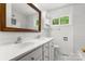 Bright bathroom featuring a double sink vanity, white subway tile, and a wood-trimmed mirror at 1725 Fallston Rd, Shelby, NC 28150