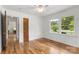 Bright bedroom featuring hardwood floors and a large window view at 1725 Fallston Rd, Shelby, NC 28150