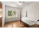 A bright bedroom featuring wood floors, a ceiling fan, and an exterior view window at 1725 Fallston Rd, Shelby, NC 28150