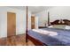 Bedroom featuring hardwood floors, a wooden 4 post bed, and a wooden side table with a lamp at 1725 Fallston Rd, Shelby, NC 28150