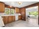 This kitchen is accented by wooden cabinets, wood paneling, and an attached dining room at 1725 Fallston Rd, Shelby, NC 28150