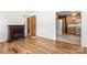 Inviting living room featuring hardwood floors and a cozy fireplace, with kitchen access at 1725 Fallston Rd, Shelby, NC 28150