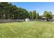 Spacious backyard featuring lush green lawn, playset, shed, gazebo, and privacy fence at 1759 Nw Pipers Ridge Cir, Conover, NC 28613