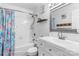 Bathroom featuring a tub-shower combo, a white vanity, and a colorful shower curtain at 1759 Nw Pipers Ridge Cir, Conover, NC 28613