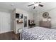 Nicely decorated bedroom featuring a ceiling fan, a wall-mounted TV, and decorative wall accents at 1759 Nw Pipers Ridge Cir, Conover, NC 28613
