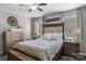 Cozy bedroom with decorative wall trim, ceiling fan, two windows, and an upholstered headboard with coordinating side tables at 1759 Nw Pipers Ridge Cir, Conover, NC 28613