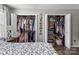 Bedroom with two closets overflowing with clothes and storage containers at 1759 Nw Pipers Ridge Cir, Conover, NC 28613