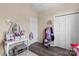 Bright bedroom featuring a vanity table with mirror, closet with double doors, and neutral walls at 1759 Nw Pipers Ridge Cir, Conover, NC 28613
