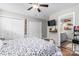 Well lit bedroom with two closets, a ceiling fan, a wall-mounted TV and an ensuite bathroom at 1759 Nw Pipers Ridge Cir, Conover, NC 28613