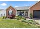 Quaint brick home featuring a charming front porch and manicured garden at 1759 Nw Pipers Ridge Cir, Conover, NC 28613