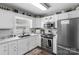 Beautiful kitchen features stainless steel appliances, white cabinets and eat-in breakfast bar at 1759 Nw Pipers Ridge Cir, Conover, NC 28613