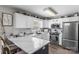 Charming kitchen boasts white countertops, stainless steel appliances, and ample cabinet space at 1759 Nw Pipers Ridge Cir, Conover, NC 28613
