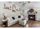 Bright living room featuring a cozy fireplace, wood floors, and a comfortable sectional sofa at 1759 Nw Pipers Ridge Cir, Conover, NC 28613