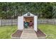 Storage shed has an open door, revealing stored lawn care equipment and tools at 1759 Nw Pipers Ridge Cir, Conover, NC 28613