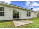 Exterior of home showcasing sliding glass doors, a small patio, and a grassy backyard at 181 Mott Rd, Mooresville, NC 28115