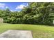 Well-manicured backyard lawn with lush foliage and trees providing shade and privacy at 181 Mott Rd, Mooresville, NC 28115