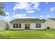 Rear exterior of home featuring a well-kept lawn, small patio and sliding glass door at 181 Mott Rd, Mooresville, NC 28115
